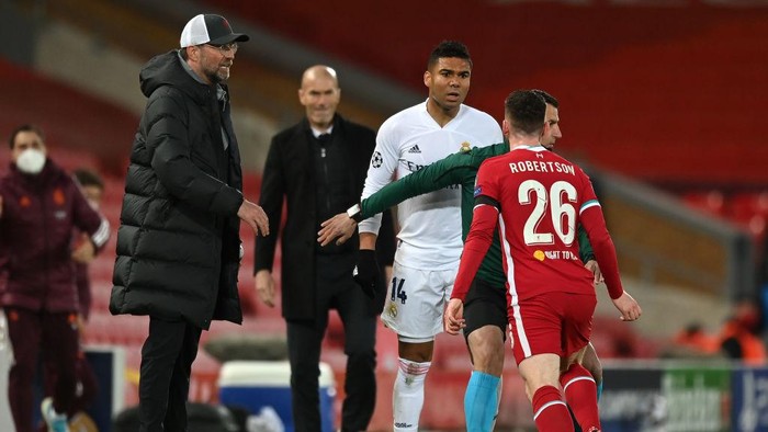 LIVERPOOL, ENGLAND - APRIL 14: Casemiro of Real Madrid clashes with Andrew Robertson of Liverpool during the UEFA Champions League Quarter Final Second Leg match between Liverpool FC and Real Madrid at Anfield on April 14, 2021 in Liverpool, England. Sporting stadiums around the UK remain under strict restrictions due to the Coronavirus Pandemic as Government social distancing laws prohibit fans inside venues resulting in games being played behind closed doors. (Photo by Shaun Botterill/Getty Images)