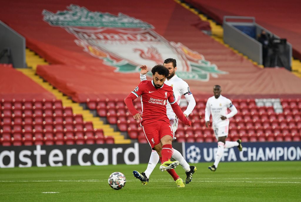 LIVERPOOL, ENGLAND - APRIL 14: Mohamed Salah of Liverpool shoots during the UEFA Champions League Quarter Final Second Leg match between Liverpool FC and Real Madrid at Anfield on April 14, 2021 in Liverpool, England. Sporting stadiums around the UK remain under strict restrictions due to the Coronavirus Pandemic as Government social distancing laws prohibit fans inside venues resulting in games being played behind closed doors. (Photo by Michael Regan/Getty Images)
