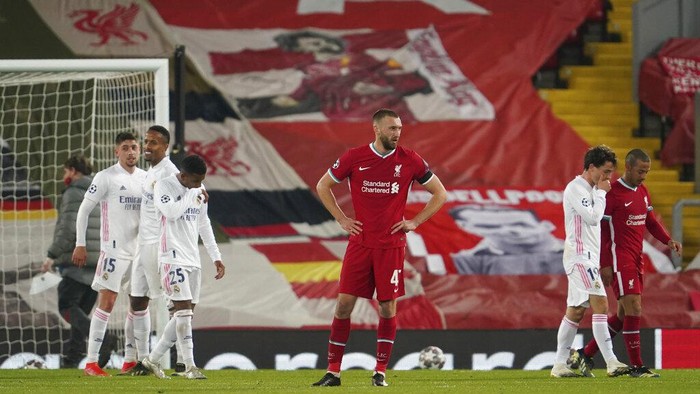 Liverpools Nathaniel Phillips, center, reacts at the end of the Champions League quarter final second leg soccer match between Liverpool and Real Madrid at Anfield stadium in Liverpool, England, Wednesday, April 14, 2021. (AP Photo/Jon Super)