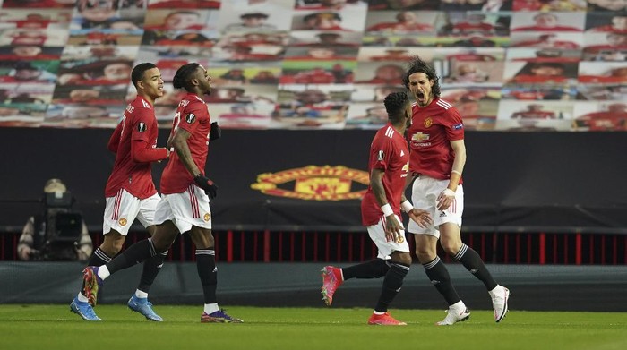 Manchester Uniteds Edinson Cavani celebrates after scoring his sides first goal during the Europa League, quarterfinal, second leg soccer match between Manchester United and Granada at the Old Trafford stadium, in Manchester, Thursday, April 15, 2021. (AP Photo/Dave Thompson)