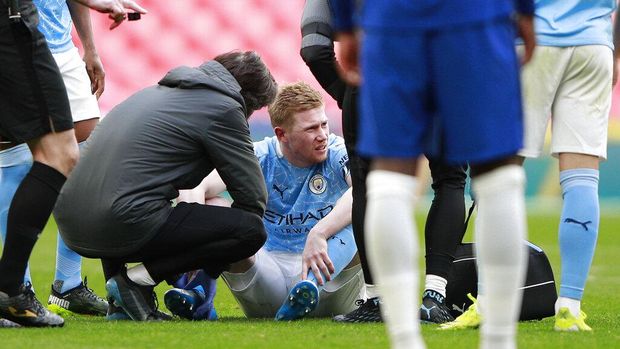 Manchester City's Kevin De Bruyne sits on the field after injuring during the English FA Cup semifinal soccer match between Chelsea and Manchester City at Wembley Stadium in London, England, Saturday, April 17, 2021. (AP Photo/Ian Walton, Pool)