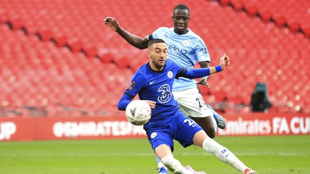 Chelsea's Hakim Ziyech, bottom, scores his side's opening goal during the English FA Cup semifinal soccer match between Chelsea and Manchester City at Wembley Stadium in London, England, Saturday, April 17, 2021. (Adam Davy, Pool via AP)