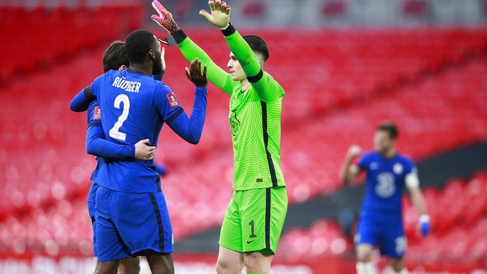 Chelseas goalkeeper Kepa Arrizabalaga, right, celebrates with his teammates after winning the English FA Cup semifinal soccer match between Chelsea and Manchester City at Wembley Stadium in London, England, Saturday, April 17, 2021. (AP Photo/Ian Walton, Pool)