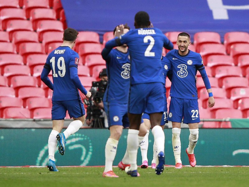 Chelsea's Hakim Ziyech, right, celebrates with his teammates after scoring his side's opening goal during the English FA Cup semifinal soccer match between Chelsea and Manchester City at Wembley Stadium in London, England, Saturday, April 17, 2021. (AP Photo/Ian Walton, Pool)