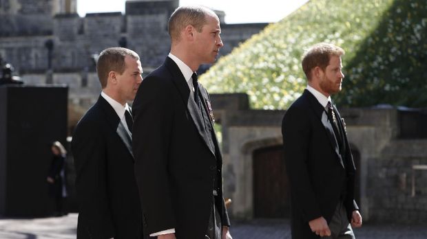 Britain's Prince Harry, right, Prince William, Peter Phillips, left, follow the coffin in a ceremonial procession for the funeral of Britain's Prince Philip inside Windsor Castle in Windsor, England Saturday April 17, 2021. Prince Philip died April 9 at the age of 99 after 73 years of marriage to Britain's Queen Elizabeth II. (Alastair Grant/Pool via AP)