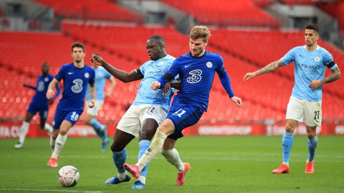 LONDON, ENGLAND - APRIL 17: Benjamin Mendy of Manchester City and Timo Werner of Chelsea  battle for the ball  during the Semi Final of the Emirates FA Cup match between Manchester City and Chelsea FC at Wembley Stadium on April 17, 2021 in London, England. Sporting stadiums around the UK remain under strict restrictions due to the Coronavirus Pandemic as Government social distancing laws prohibit fans inside venues resulting in games being played behind closed doors.  (Photo by Adam Davy - Pool/Getty Images)