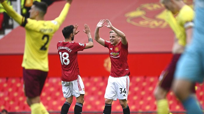 Manchester Uniteds Bruno Fernandes, left, and Manchester Uniteds Donny van der Beek celebrate third goal during the English Premier League soccer match between Manchester United and Burnley at the Old Trafford stadium in Manchester, England, Sunday, April 18, 2021. (Gareth Copley/Pool via AP)
