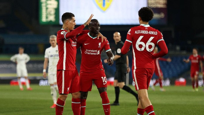 LEEDS, ENGLAND - APRIL 19: Sadio Mane of Liverpool celebrates with Roberto Firmino and Trent Alexander-Arnold after scoring his teams first goal during the Premier League match between Leeds United and Liverpool at Elland Road on April 19, 2021 in Leeds, England. Sporting stadiums around the UK remain under strict restrictions due to the Coronavirus Pandemic as Government social distancing laws prohibit fans inside venues resulting in games being played behind closed doors.  (Photo by Clive Brunskill/Getty Images)