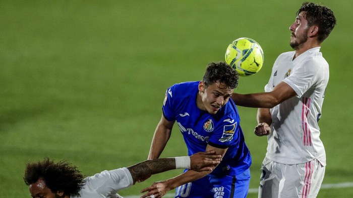 Getafes Enes Unal, center, duels for the ball with Real Madrids Victor Chust, right, and Real Madrids Marcelo during the Spanish La Liga soccer match between Getafe and Real Madrid at the Alfonso Perez stadium in Getafe, Spain, Sunday, April 18, 2021. (AP Photo/Manu Fernandez)