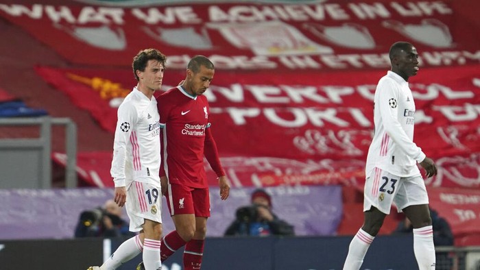 Real Madrids Alvaro Odriozola, left, greets Liverpools Thiago at the end of the Champions League quarter final second leg soccer match between Liverpool and Real Madrid at Anfield stadium in Liverpool, England, Wednesday, April 14, 2021. (AP Photo/Jon Super)