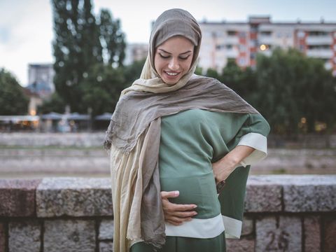 Cute and lovely young Muslim woman spending her time in the city.