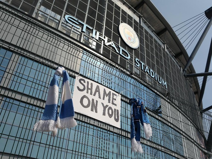 MANCHESTER, ENGLAND - APRIL 20: A sign which reads 'Shame On You' is placed between two Manchester City scarves outside the Etihad Stadium on April 20, 2021 in Manchester, England. Six English premier league teams have announced they are part of plans for a breakaway European Super League. Arsenal, Manchester United, Manchester City, Liverpool, Chelsea and Tottenham Hotspur will join 12 other European teams in a closed league similar to that of the NFL American Football League. In a statement released last night, the new competition 