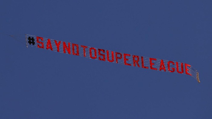 LEEDS, ENGLAND - APRIL 19: A sign is trailed by a plane with a slogan against a proposed new European Super League over the stadium during the warm up for the Premier League match between Leeds United and Liverpool at Elland Road on April 19, 2021 in Leeds, England. Sporting stadiums around the UK remain under strict restrictions due to the Coronavirus Pandemic as Government social distancing laws prohibit fans inside venues resulting in games being played behind closed doors. (Photo by Clive Brunskill/Getty Images)