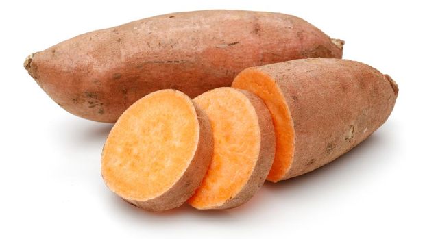 Sweet potato with slices isolated on white background