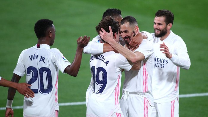CADIZ, SPAIN - APRIL 21: Alvaro Odriozola of Real Madrid celebrates with Karim Benzema after scoring their sides second goal during the La Liga Santander match between Cadiz CF and Real Madrid at Estadio Ramon de Carranza on April 21, 2021 in Cadiz, Spain. Sporting stadiums around Spain remain under strict restrictions due to the Coronavirus Pandemic as Government social distancing laws prohibit fans inside venues resulting in games being played behind closed doors. (Photo by Fran Santiago/Getty Images)