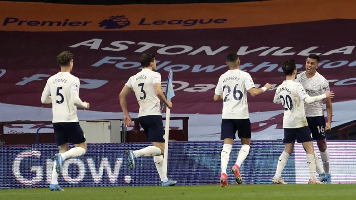 Manchester Citys Rodrigo, right, celebrates after scoring his sides second goal during the English Premier League soccer match between Aston Villa and Manchester City at Villa Park Stadium in Birmingham, England, Wednesday, April 21, 2021. (Geoff Caddick/Pool via AP)