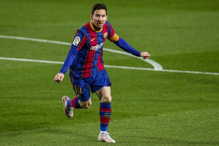 Barcelonas Lionel Messi celebrates after scoring the opening goal during the Spanish La Liga soccer match between FC Barcelona and Getafe at the Camp Nou stadium in Barcelona, Spain, Thursday, April 22, 2021. (AP Photo/Joan Monfort)