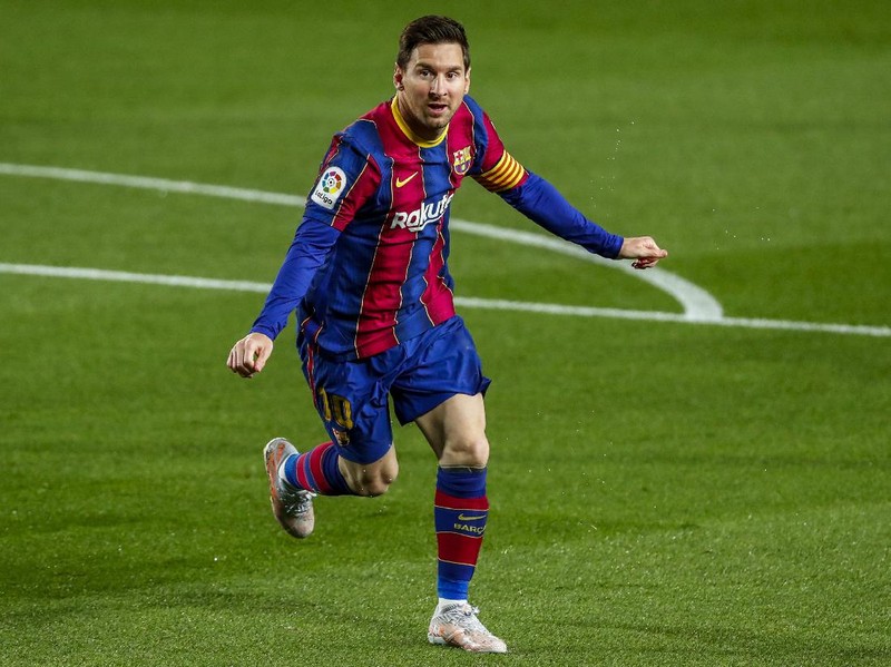 Barcelona's Lionel Messi celebrates after scoring the opening goal during the Spanish La Liga soccer match between FC Barcelona and Getafe at the Camp Nou stadium in Barcelona, Spain, Thursday, April 22, 2021. (AP Photo/Joan Monfort)