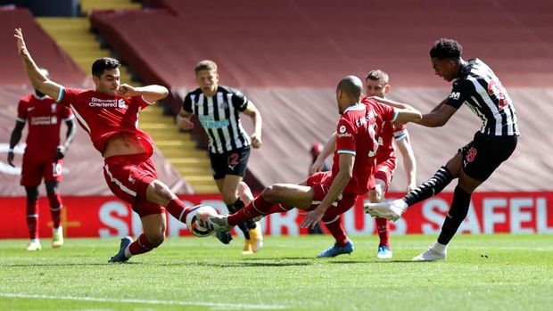 LIVERPOOL, ENGLAND - APRIL 24: Joe Willock of Newcastle United scores their side's first goal during the Premier League match between Liverpool and Newcastle United at Anfield on April 24, 2021 in Liverpool, England. Sporting stadiums around the UK remain under strict restrictions due to the Coronavirus Pandemic as Government social distancing laws prohibit fans inside venues resulting in games being played behind closed doors.  (Photo by David Klein - Pool/Getty Images)