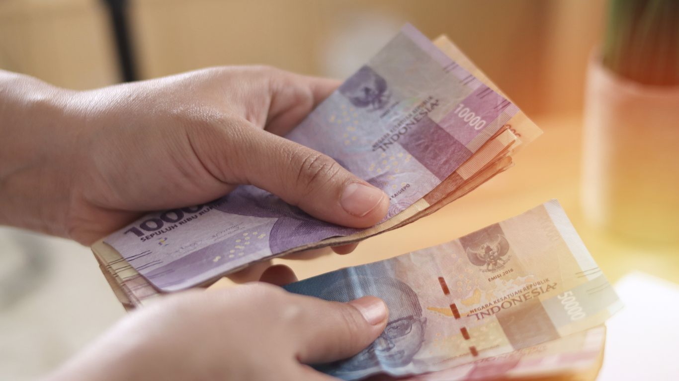 Close up of a person counting money, Uang Indonesian rupiah, cash in hand concept