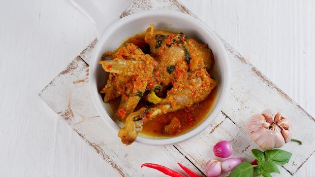 Indonesian traditional food.Ayam woku is a typical dish of Manado, North Sulawesi. The chicken is cooked with various spices, very delicious and rich in flavor