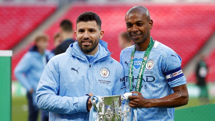 Manchester Citys Sergio Aguero and Fernandinho, right, pose with the trophy at the end of the English League Cup final soccer match between Manchester City and Tottenham Hotspur at Wembley stadium in London, Sunday, April 25, 2021. Manchester City won 1-0. (AP Photo/Alastair Grant)