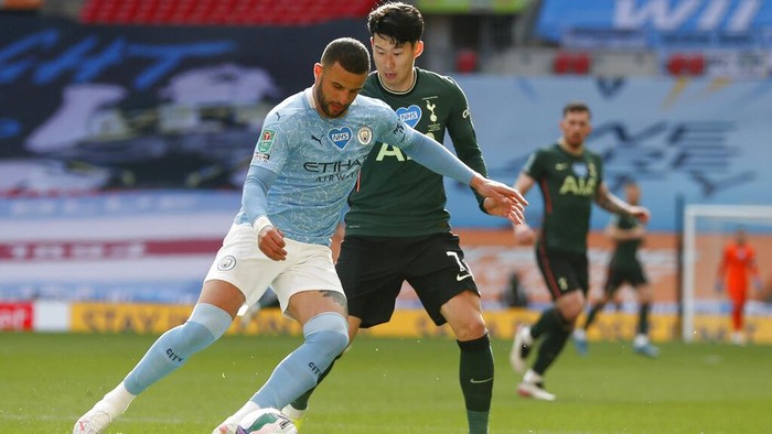 Tottenhams Son Heung-min vies for the ball with Manchester Citys Kyle Walker, left, during the English League Cup final soccer match between Manchester City and Tottenham Hotspur at Wembley stadium in London, Sunday, April 25, 2021. (AP Photo/Alastair Grant)