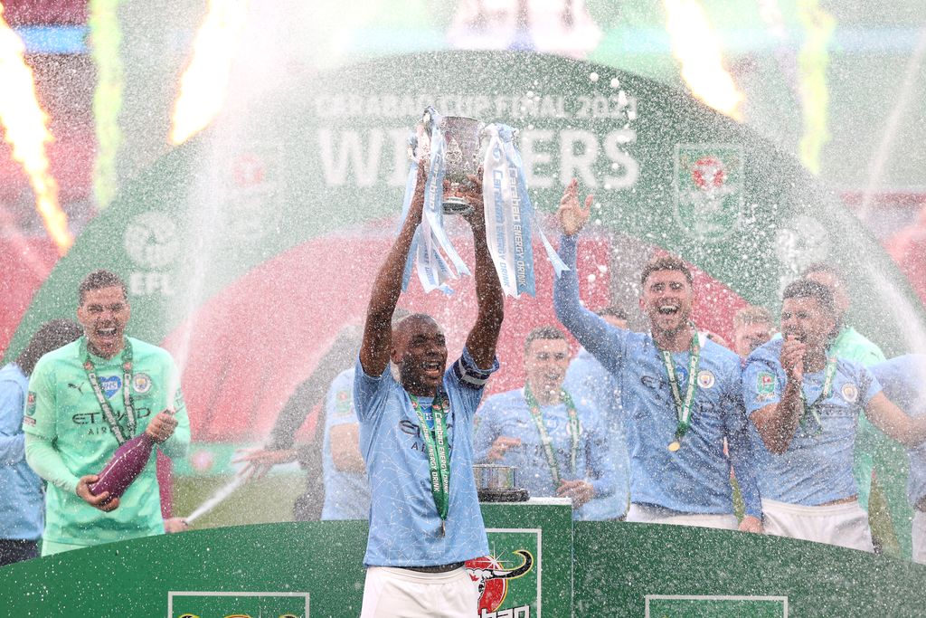 LONDON, ENGLAND - APRIL 25: Fernandinho of Manchester City lifts the Carabao Cup Trophy as his team celebrate victory after the Carabao Cup Final between Manchester City and Tottenham Hotspur at Wembley Stadium on April 25, 2021 in London, England. 8,000 fans are due to watch the game at Wembley, the most at an outdoor sporting event in the UK since the coronavirus pandemic started in March, 2020. Each team has been given an allocation of 2,000 with the remaining tickets split between local residents and NHS staff. (Photo by Clive Rose/Getty Images)