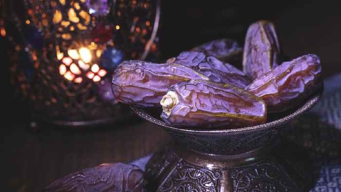 Ramadan concept with dried dates and lantern.