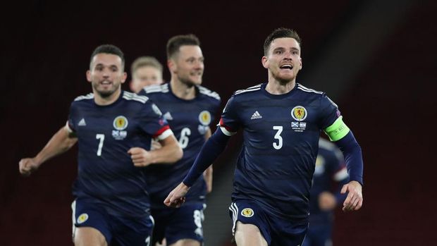 GLASGOW, SCOTLAND - OCTOBER 08: Andy Robertson of Scotland celebrates after his teams victory in the penalty shoot out during the UEFA EURO 2020 Play-Off semi-finals match between Scotland and Israel at Hampden Park on October 08, 2020 in Glasgow, Scotland. Football Stadiums around Europe remain empty due to the Coronavirus Pandemic as Government social distancing laws prohibit fans inside venues resulting in fixtures being played behind closed doors. (Photo by Ian MacNicol/Getty Images)