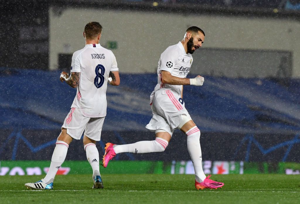 MADRID, SPAIN - APRIL 27 Karim Benzema of Real Madrid celebrates with Toni Kroos after scoring their side's first goal during the UEFA Champions League Semi Final First Leg match between Real Madrid and Chelsea FC at Estadio Alfredo Di Stefano on April 27, 2021 in Madrid, Spain. Sporting stadiums around Spain remain under strict restrictions due to the Coronavirus Pandemic as Government social distancing laws prohibit fans inside venues resulting in games being played behind closed doors.  (Photo by David Ramos/Getty Images)
