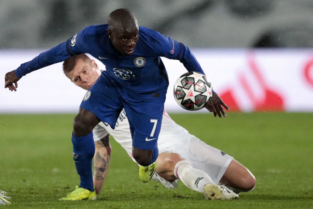 Chelsea's N'Golo Kante gets the ball past Real Madrid's Toni Kroos, in the background, during the Champions League semifinal first leg soccer match between Real Madrid and Chelsea at the Alfredo di Stefano stadium in Madrid, Spain, Tuesday, April 27, 2021. (AP Photo/Bernat Armangue)