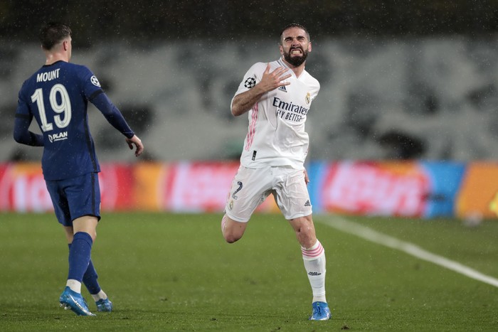 Real Madrids Dani Carvajal reacts next to Chelseas Mason Mount, left, during the Champions League semifinal first leg soccer match between Real Madrid and Chelsea at the Alfredo di Stefano stadium in Madrid, Spain, Tuesday, April 27, 2021. (AP Photo/Bernat Armangue)