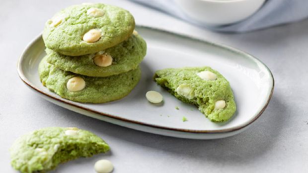 close-up of green tea matcha cookies with white chocolate in plate. Vegan alternative food. gray background. horizontal image