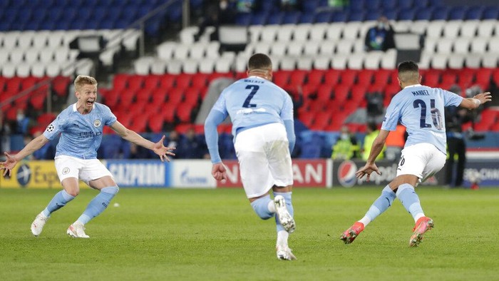 Manchester Citys Riyad Mahrez, right, celebrates with teammates after scoring his sides second goal during the Champions League semifinal first leg soccer match between Paris Saint Germain and Manchester City at the Parc des Princes stadium, in Paris, France , Wednesday, April 28, 2021. (AP Photo/Thibault Camus)