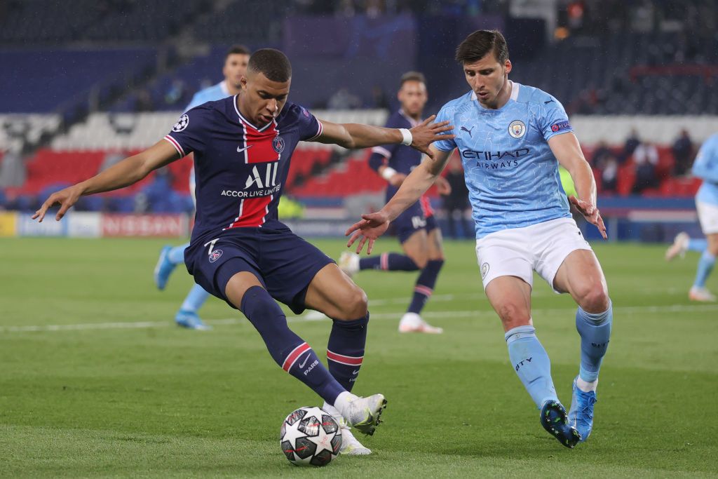 PARIS, FRANCE - APRIL 28: Kylian Mbappe of Paris Saint-Germain is challenged by Ruben Dias of Manchester City the ball during the UEFA Champions League Semi Final First Leg match between Paris Saint-Germain and Manchester City at Parc des Princes on April 28, 2021 in Paris, France. Sporting stadiums around France remain under strict restrictions due to the Coronavirus Pandemic as Government social distancing laws prohibit fans inside venues resulting in games being played behind closed doors. (Photo by Alex Grimm/Getty Images)