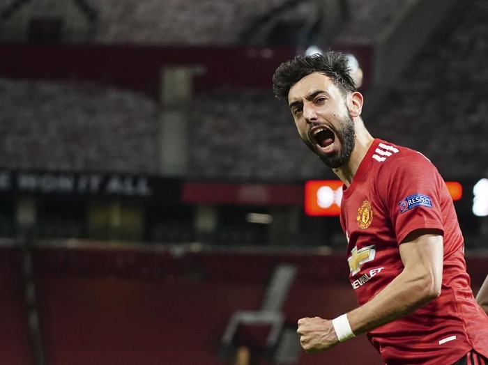 Manchester Uniteds Bruno Fernandes celebrates after scoring his sides fourth goal during the Europa League semi final, first leg soccer match between Manchester United and Roma at Old Trafford in Manchester, England, Thursday, April 29, 2021. (AP Photo/Jon Super)