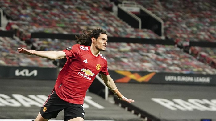 Manchester Uniteds Edinson Cavani celebrates after scoring his sides second goal during the Europa League semi final, first leg soccer match between Manchester United and Roma at Old Trafford in Manchester, England, Thursday, April 29, 2021. (AP Photo/Jon Super)