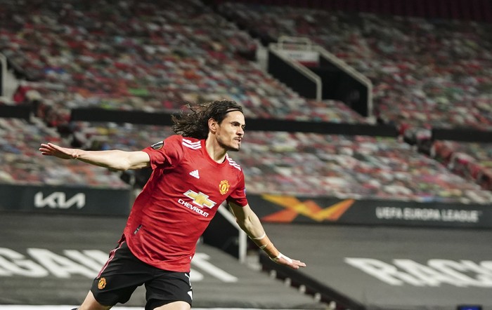 Manchester Uniteds Edinson Cavani celebrates after scoring his sides second goal during the Europa League semi final, first leg soccer match between Manchester United and Roma at Old Trafford in Manchester, England, Thursday, April 29, 2021. (AP Photo/Jon Super)