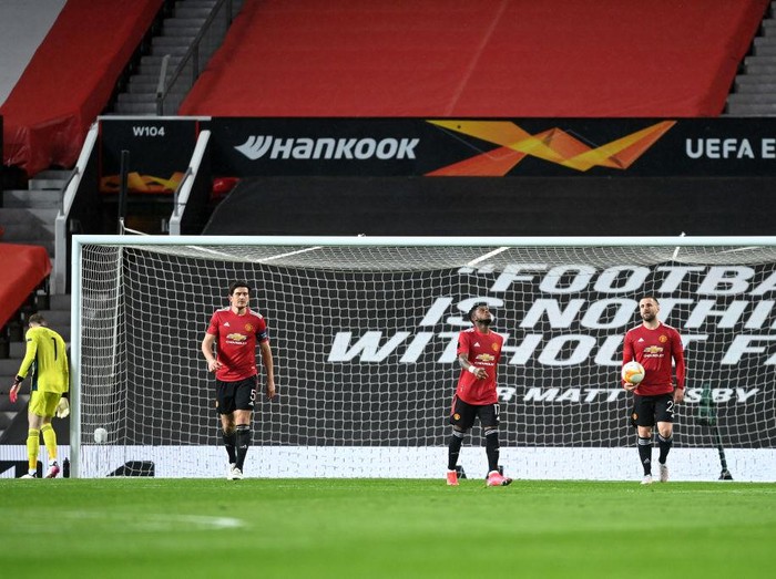 MANCHESTER, ENGLAND - APRIL 29: (L-R) Harry Maguire, Fred and Luke Shaw of Manchester United look dejected after conceding a second goal during the UEFA Europa League Semi-final First Leg match between Manchester United and AS Roma at Old Trafford on April 29, 2021 in Manchester, England. Sporting stadiums around Europe remain under strict restrictions due to the Coronavirus Pandemic as Government social distancing laws prohibit fans inside venues resulting in games being played behind closed doors. (Photo by Michael Regan/Getty Images)