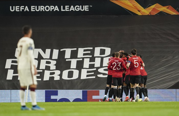 Manchester Uniteds Bruno Fernandes celebrates with teammates after scoring his sides opening goal during the Europa League semi final, first leg soccer match between Manchester United and Roma at Old Trafford in Manchester, England, Thursday, April 29, 2021. (AP Photo/Jon Super)