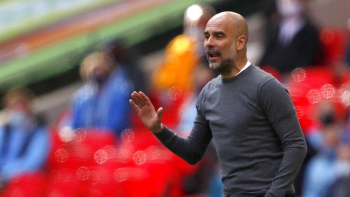 Manchester Citys head coach Pep Guardiola gestures during the English League Cup final soccer match between Manchester City and Tottenham Hotspur at Wembley stadium in London, Sunday, April 25, 2021. (AP Photo/Alastair Grant)