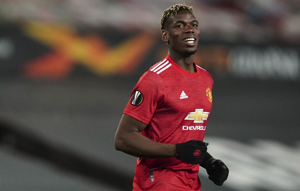 Manchester United's Paul Pogba smiles during the Europa League semi final, first leg soccer match between Manchester United and Roma at Old Trafford in Manchester, England, Thursday, April 29, 2021. (AP Photo/Jon Super)