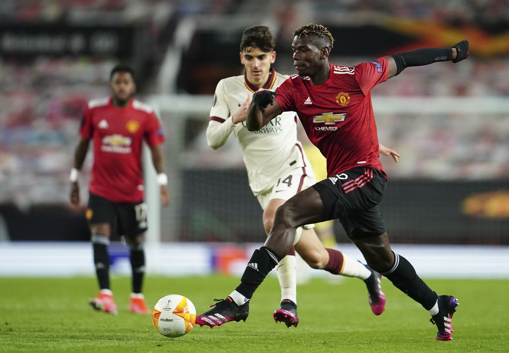 Manchester United's Paul Pogba smiles during the Europa League semi final, first leg soccer match between Manchester United and Roma at Old Trafford in Manchester, England, Thursday, April 29, 2021. (AP Photo/Jon Super)