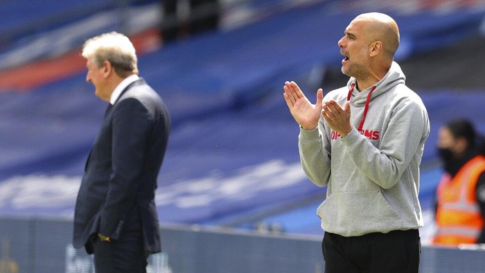 Manchester Citys head coach Pep Guardiola gestures as he watches play during the English Premier League soccer match between Crystal Palace and Manchester City at Selhurst Park in London, England, Saturday, May 1, 2021. (AP Photo/Catherine Ivill/Pool)