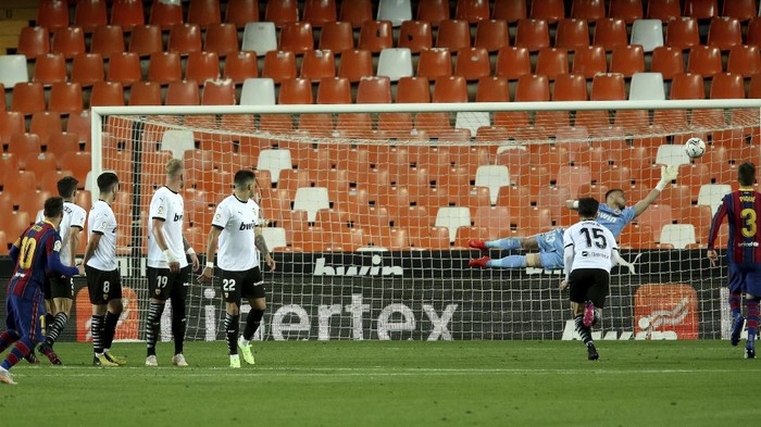 Barcelonas Lionel Messi scores his sides 3rd goal during the Spanish La Liga soccer match between Valencia and Barcelona at the Mestalla stadium in Valencia, Spain, Sunday, May 2, 2021. (AP Photo/Alberto Saiz)