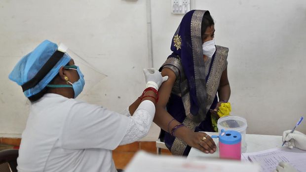 A woman receives the AstraZeneca vaccine for COVID-19 at a hospital in Prayagraj, India. Saturday, May 1, 2021. In hopes of taming a monstrous spike in COVID-19 infections, India opened vaccinations to all adults Saturday, launching a huge inoculation effort that was sure to tax the limits of the federal government, the country's vaccine factories and the patience of its 1.4 billion people. (AP Photo/Rajesh Kumar Singh)