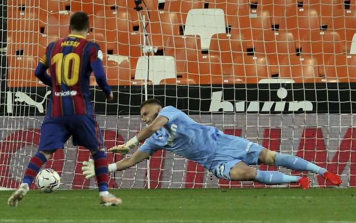 Barcelonas Lionel Messi throws a penalty and scores his sides first goal during the Spanish La Liga soccer match between Valencia and Barcelona at the Mestalla stadium in Valencia, Spain, Sunday, May 2, 2021. (AP Photo/Alberto Saiz)
