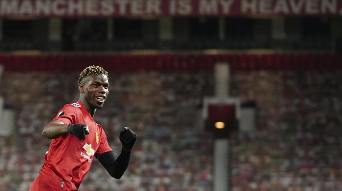 Manchester Uniteds Paul Pogba celebrates after scoring his sides fifth goal during the Europa League semi final, first leg soccer match between Manchester United and Roma at Old Trafford in Manchester, England, Thursday, April 29, 2021. (AP Photo/Jon Super)