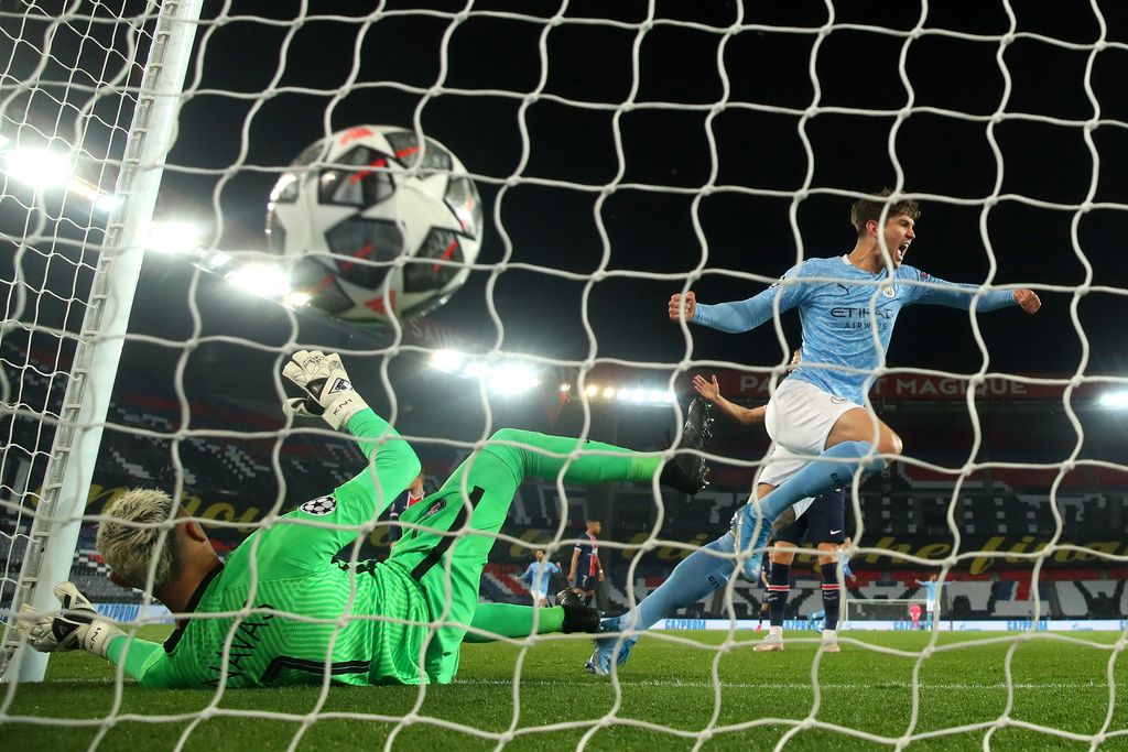 PARIS, FRANCE - APRIL 28: John Stones of Manchester City celebrates their side's first goal scored by Kevin De Bruyne of Manchester City (not pictured) as Keylor Navas of Paris Saint-Germain looks dejected during the UEFA Champions League Semi Final First Leg match between Paris Saint-Germain and Manchester City  at Parc des Princes on April 28, 2021 in Paris, France. Sporting stadiums around France remain under strict restrictions due to the Coronavirus Pandemic as Government social distancing laws prohibit fans inside venues resulting in games being played behind closed doors. (Photo by Alex Grimm/Getty Images)